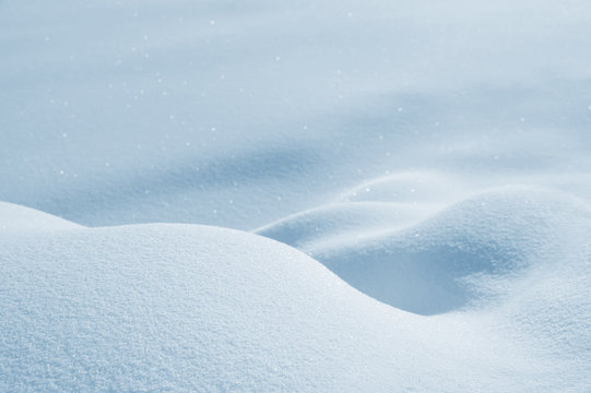 Winter bright background with deep snow drifts