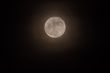 Rare full moon not seen since 1948 through a veil of high clouds