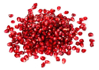 fresh exotic ruby pomegranate seeds, scattered on white background