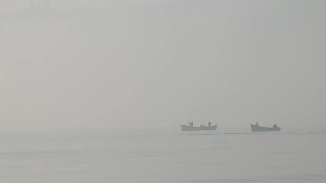 Tall yach sailing in the sea in foggy misty day.