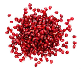 fresh exotic ruby pomegranate seeds, scattered on isolated white background