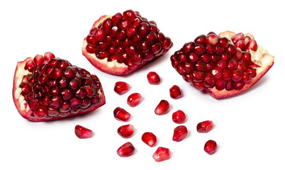 pieces of ruby delicious  pomegranate on isolated white background