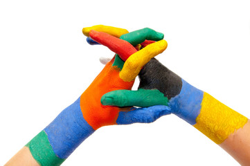 Child's hands painted with multicolored finger paints on white b