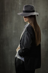 Fototapety  Portrait of sexy girl in classic jacket, shirt and a hat on his