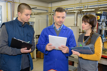 teachers and students checking machinery procedure