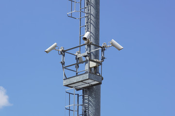 security cctv cameras on a pole with blue sky background