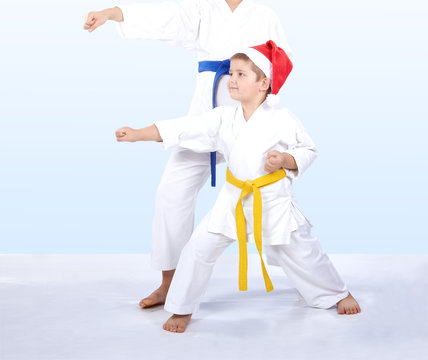 Kids in karategi are beating punch arm