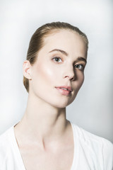 Fototapeta premium Portrait of young blonde beautiful girl in white T-shirt