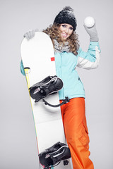 Young beautiful woman in winter clothes and snowboard