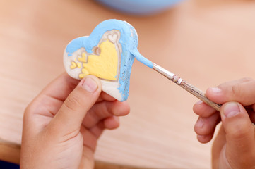 process of painting the baby products from clay heart