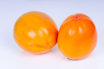 ripe persimmon on a white background closeup. horizontal photo