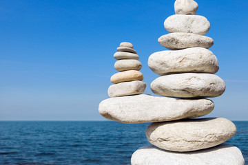 Concept of balance and harmony. White rocks zen on the sea.