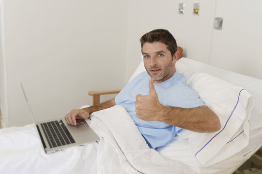 patient in hospital suffering disease and working at the clinic bed with laptop computer smiling happy