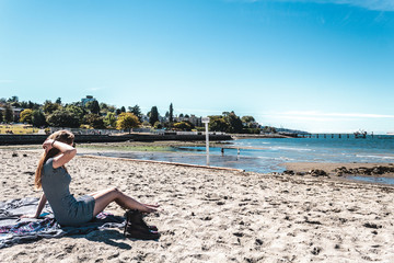 Fototapeta na wymiar Girl at Kitsilano Beach in Vancouver, Canada
