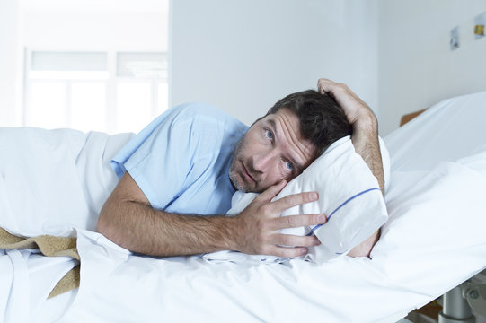 desperate man at hospital bed alone sad and devastated suffering depression _