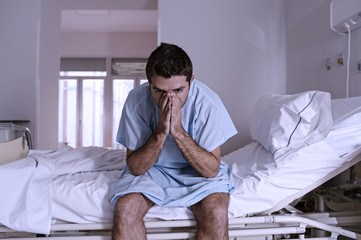 desperate man sitting at hospital bed alone sad and devastated s