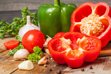 Fresh vegetables on a wooden table. Preparation. Healthy diet. Ripe. Eggplants, tomatoes, pepper, garlic.