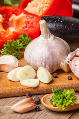 Fresh vegetables on a wooden table. Preparation. Healthy diet. Ripe. Eggplants, tomatoes, pepper, garlic.