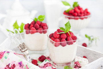 Delicious sweet  mousse decorated with fresh raspberries