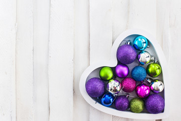 Сhristmas card with wooden heart, balls, decoration and fir-tre