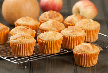 Homebaked Cupcakes In Paper Cases. Wooden Table. Pumpkins. Apple