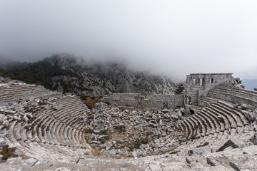 Fototapeta na wymiar Top view of amphitheater of Termessos Antique City with mist in Antalya, Turkey