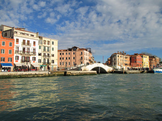 Fototapeta premium Colorful old buildings and the white stone bridge seen from the Grand Canal of Venice, Italy 