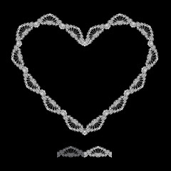 White Heart shape is made of lace doily isolated on black backgr