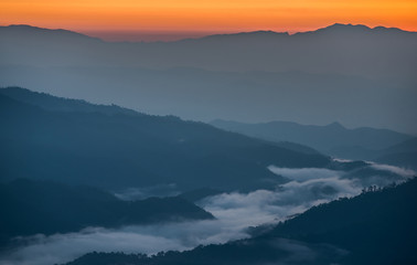 Beautiful sunrise scene with misty in morning in forest valley in Huay Nam Dang National Park. Chiang Mai, Thailand.