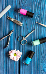 flower, nail polish and manicure set on dark wooden background