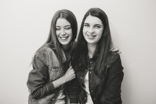 Two fashion young women posing in studio