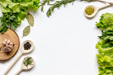 Fototapeta na wymiar frame spices and fresh herbs on white table top view