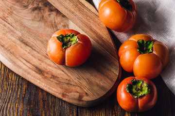 Ripe Persimmons on Cutting Board