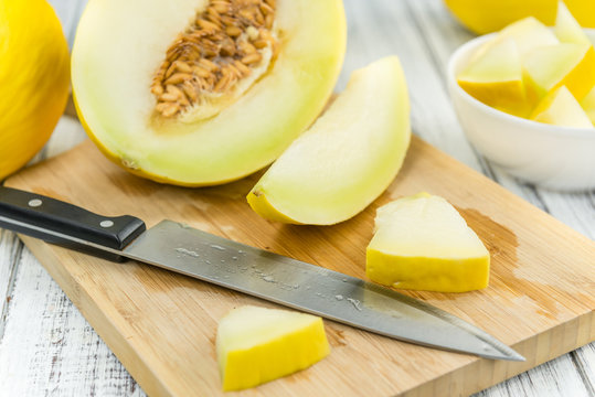 Portion of Yellow Honeydew Melon on wooden background (selective