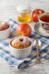 Baked red apples with granola and honey, close up view