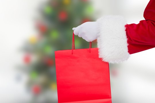 Santa claus holding shopping bag
