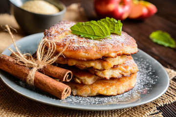 Sweet pancakes made of apple, curd and cinnamon