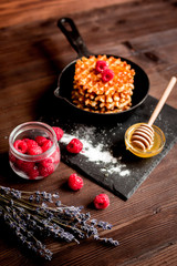 Festive composition - waffles and lavender on wooden background