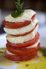 Beautifully arranged fine dining tomato and mozzarella cheese 