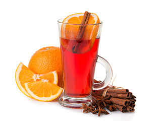Glass with mulled wine, spices and fruits isolated on white