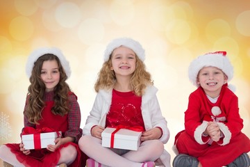 Kids in santa hat holding gifts