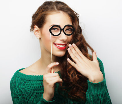 Attractive playful young woman with false glasses