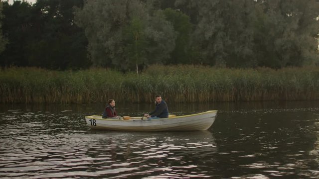 Father and Son on the Boat. Father Rows the Boat. Shot on RED Cinema Camera in 4K (UHD) 