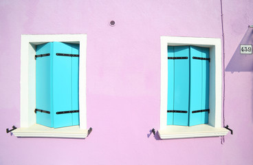 two windows closed in colorful house on the island of Burano in