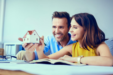 Happy couple planning new home design