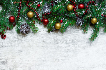 Fototapeta na wymiar christmas background with fir branches and decorations covered with snow