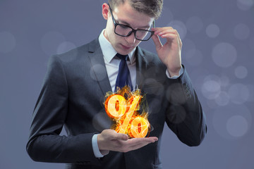 Businessman with percent sign in high interest concept