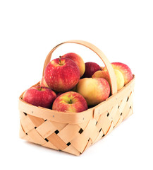 Basket full of delicious red apples, on white