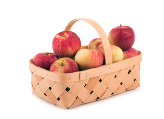 Apples in a wooden basket, on white
