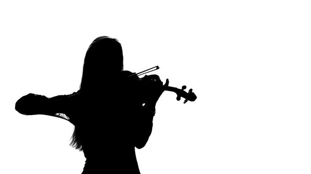 Woman professional violinist playing the fiddle. Silhouette